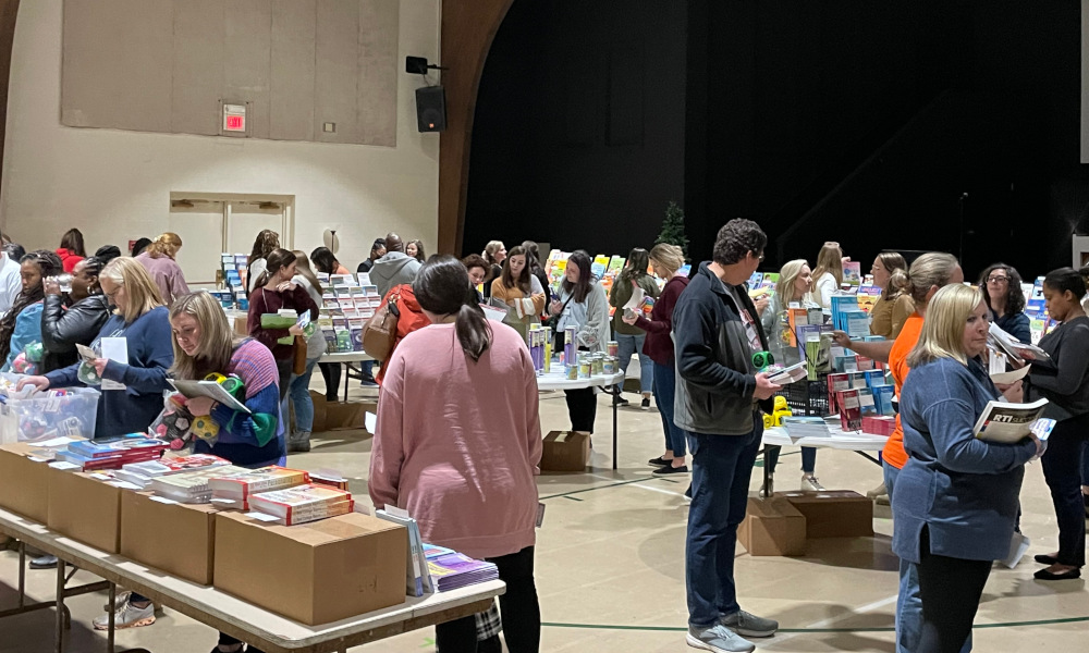 People shopping for books at a National Center for Youth Issues Showcase.